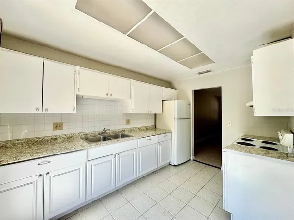 a kitchen with a sink stove and refrigerator