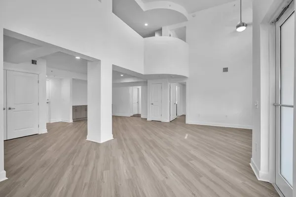 a view of an empty room and wooden floor