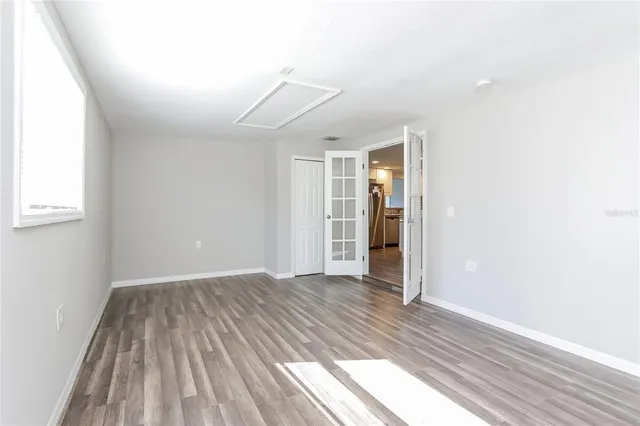 wooden floor in an empty room with a window