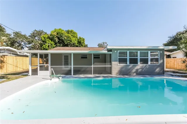 a view of house with backyard space and balcony
