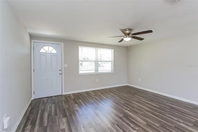 wooden floor in an empty room with a window