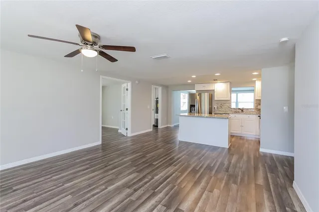 a view of a kitchen with wooden floor and a kitchen