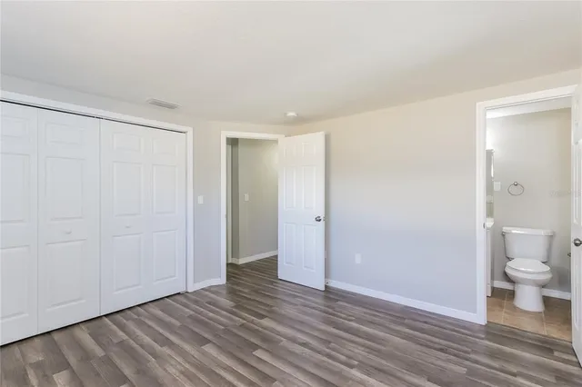 a view of an empty room and wooden floor