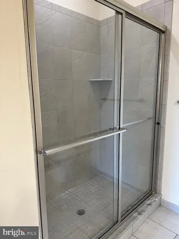 a bathroom with a glass shower door