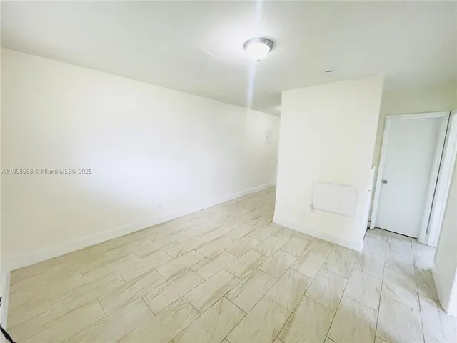 an empty room with wooden floor