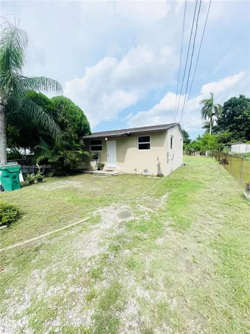 a front view of house with yard and trees