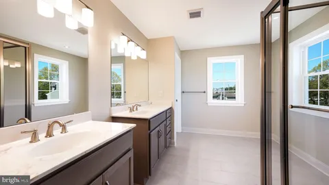 a bathroom with double sink and a mirror