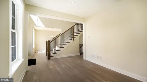 a view of an entryway with wooden floor and windows