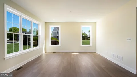 a view of a hallway view with wooden floor and staircase