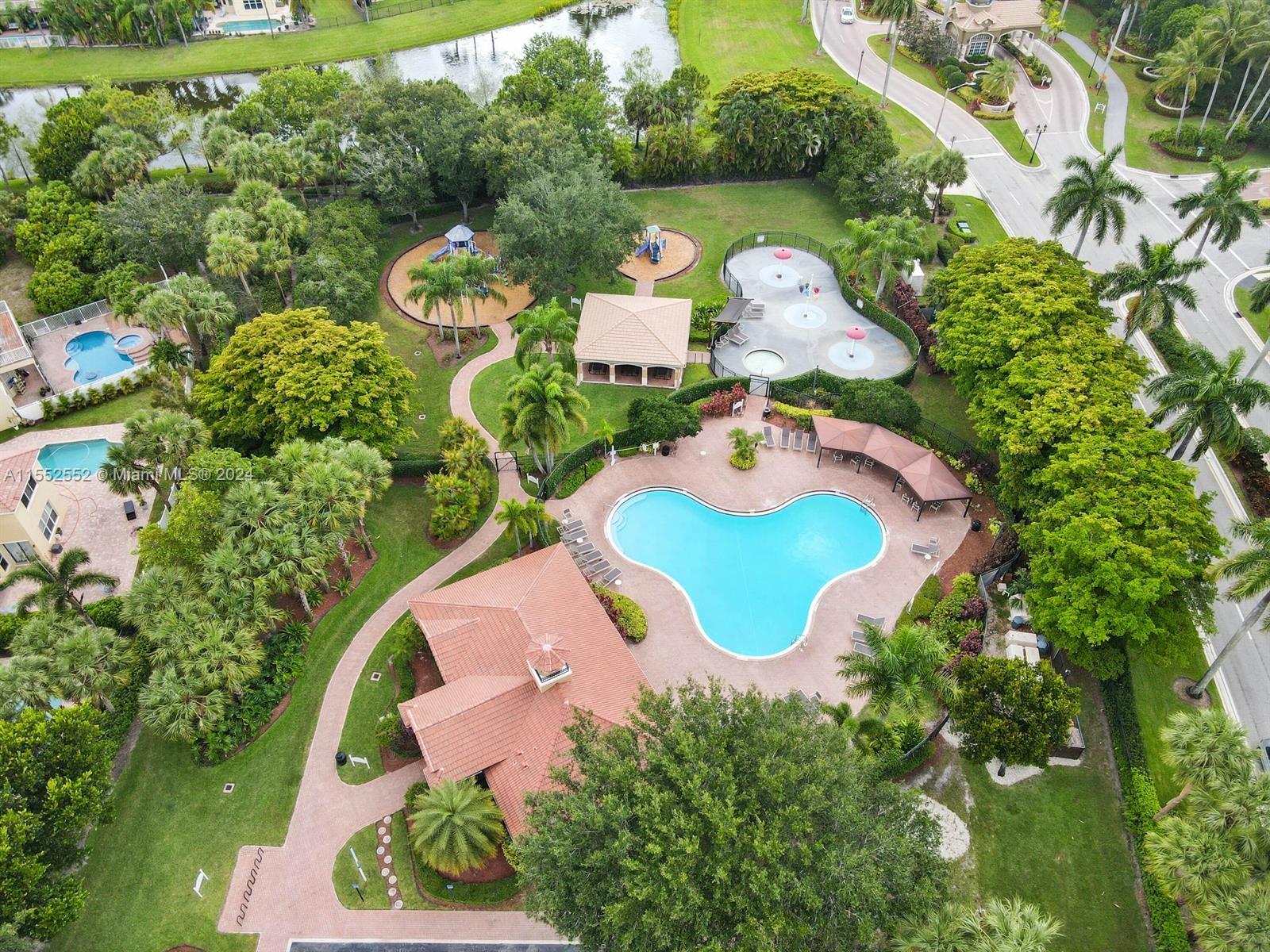 an aerial view of a house with a swimming pool a yard and outdoor seating