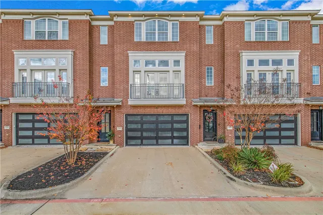 front view of a brick house with large windows