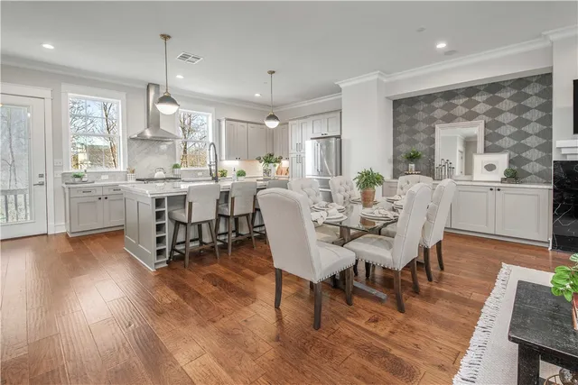 a view of a dining room with furniture window and wooden floor