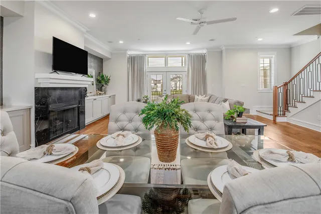 a dining room with furniture a fireplace and a flat screen tv