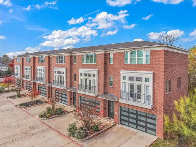 a view of a brick building next to a yard