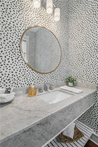 a spacious bedroom with a bed and a flat tv screen on the dresser