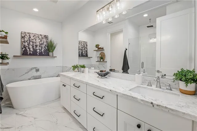 a white bath tub sitting next to a white sink
