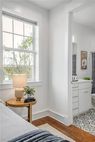 a bathroom with a sink a toilet and mirror
