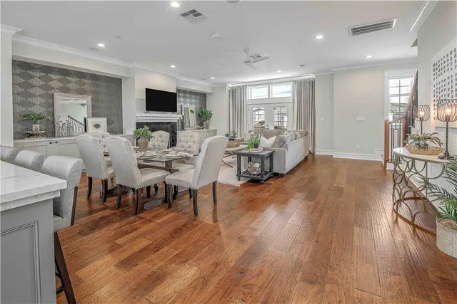 a living room with furniture wooden floor and a flat screen tv