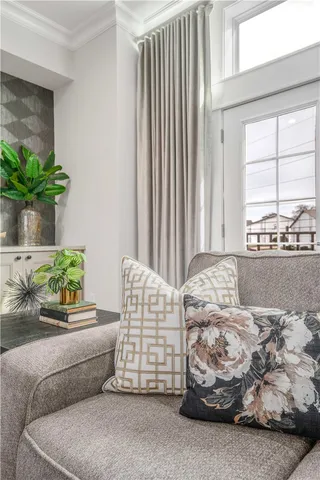 a living room with furniture and a potted plant