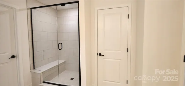 a bathroom with a glass shower door