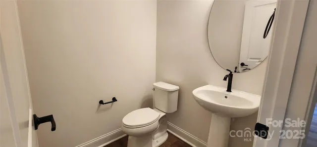 a bathroom with a sink toilet and a mirror