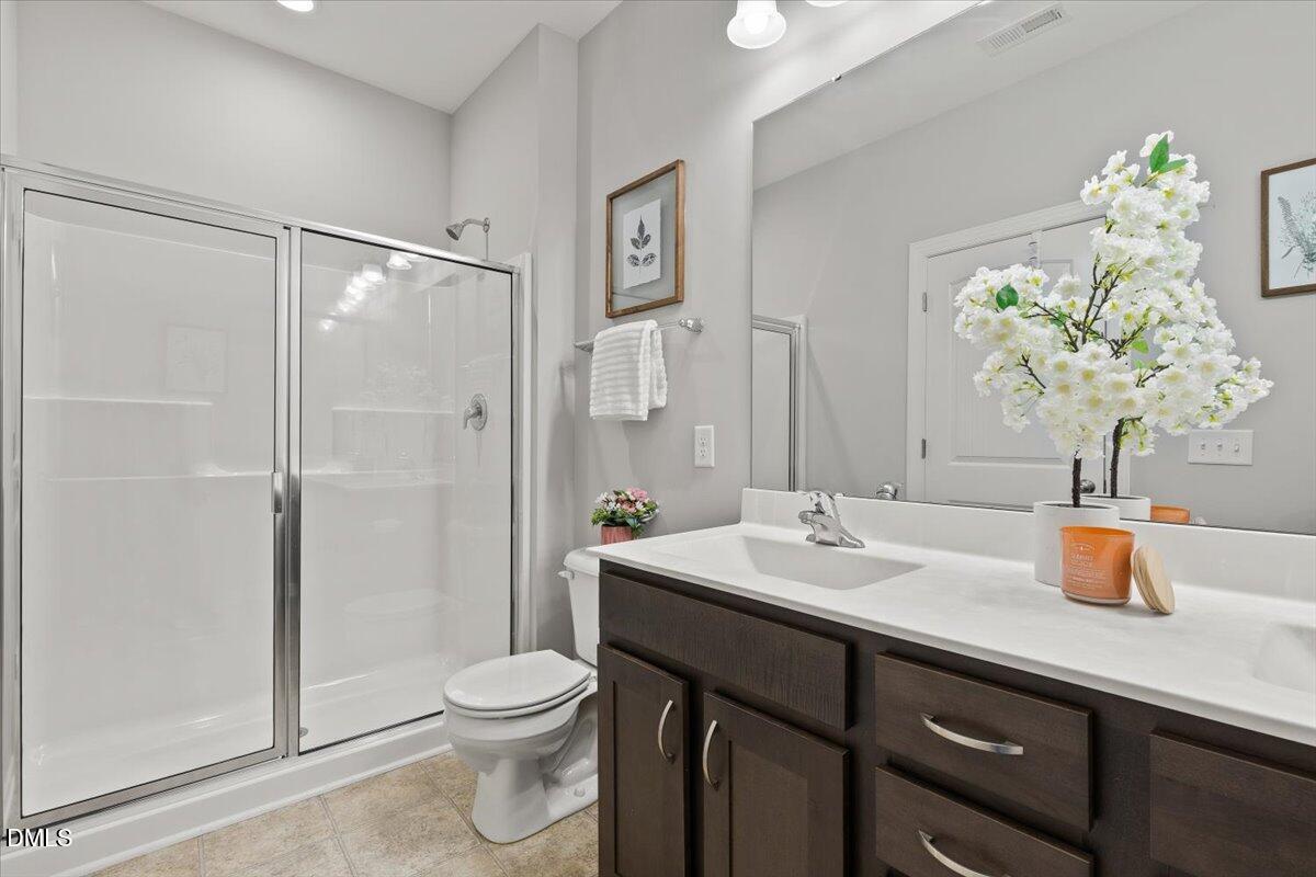 435 Leighann Ridge Lane Rolesville, NC 27571 - Photo 12 of 21 a bathroom with a sink a toilet and shower