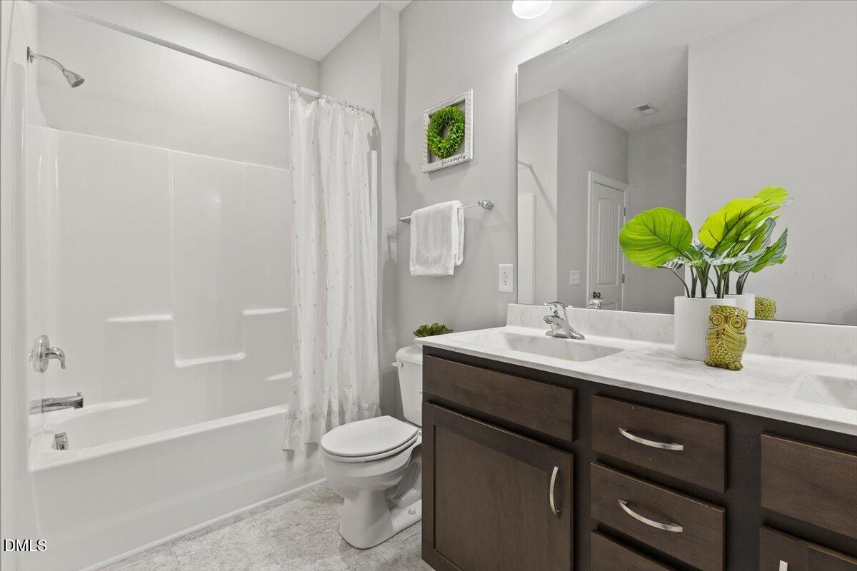 435 Leighann Ridge Lane Rolesville, NC 27571 - Photo 15 of 21 a bathroom with a granite countertop sink a toilet and shower