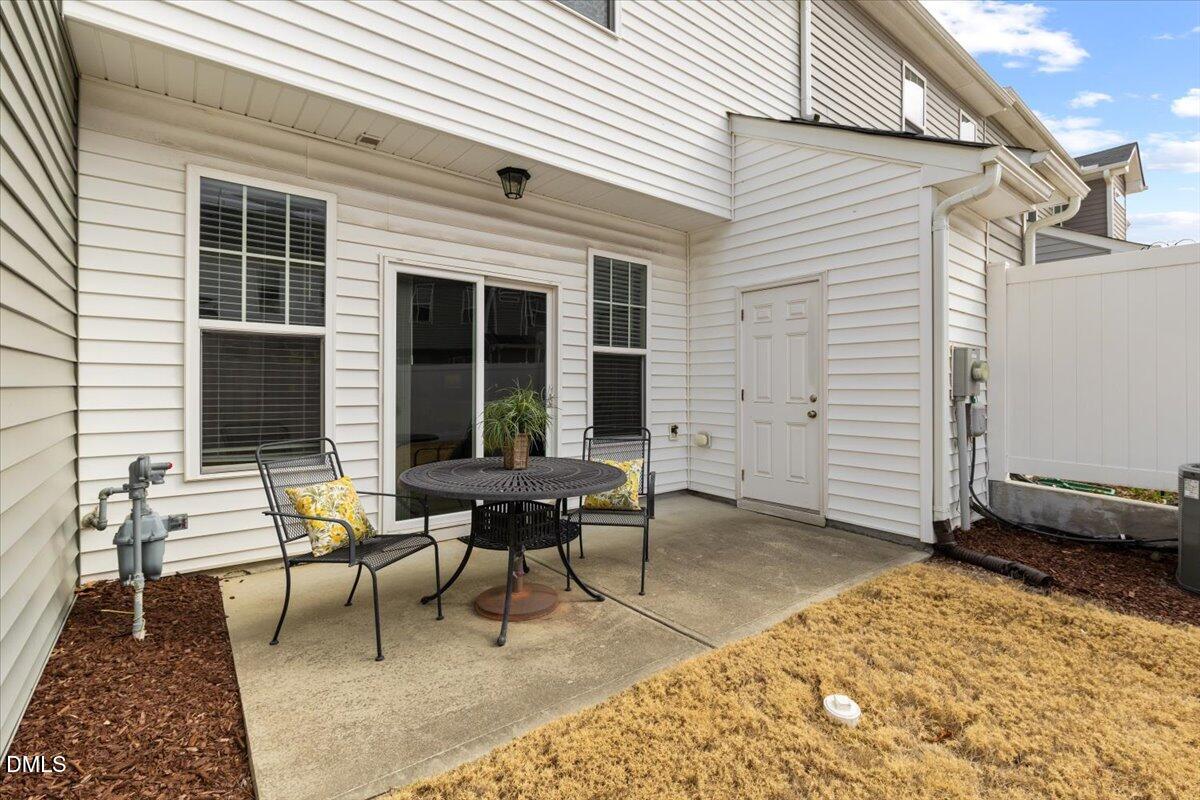 435 Leighann Ridge Lane Rolesville, NC 27571 - Photo 16 of 21 a backyard of a house with glass table and chairs