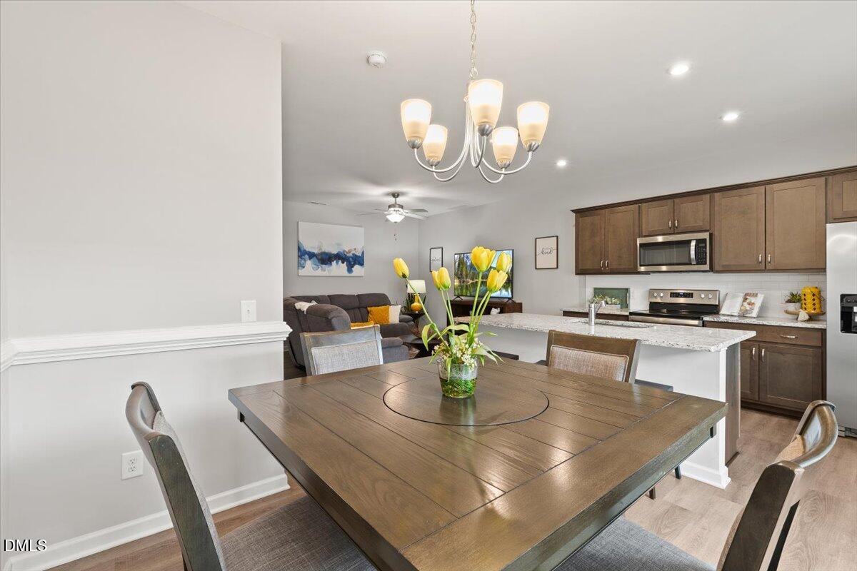 435 Leighann Ridge Lane Rolesville, NC 27571 - Photo 9 of 21 a kitchen with a dining table and chairs