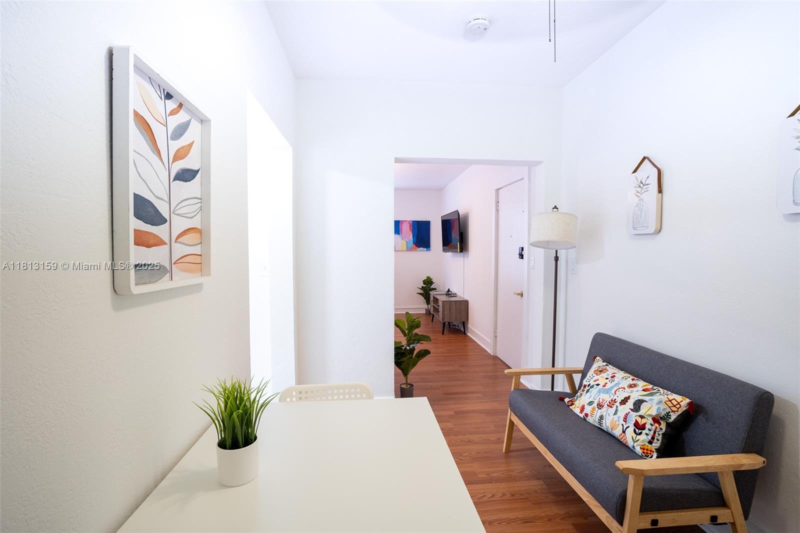 444 Ponce De Leon Boulevard, Unit 6 Coral Gables, FL 33134 - Photo 17 of 22 a living room with furniture and wooden floor