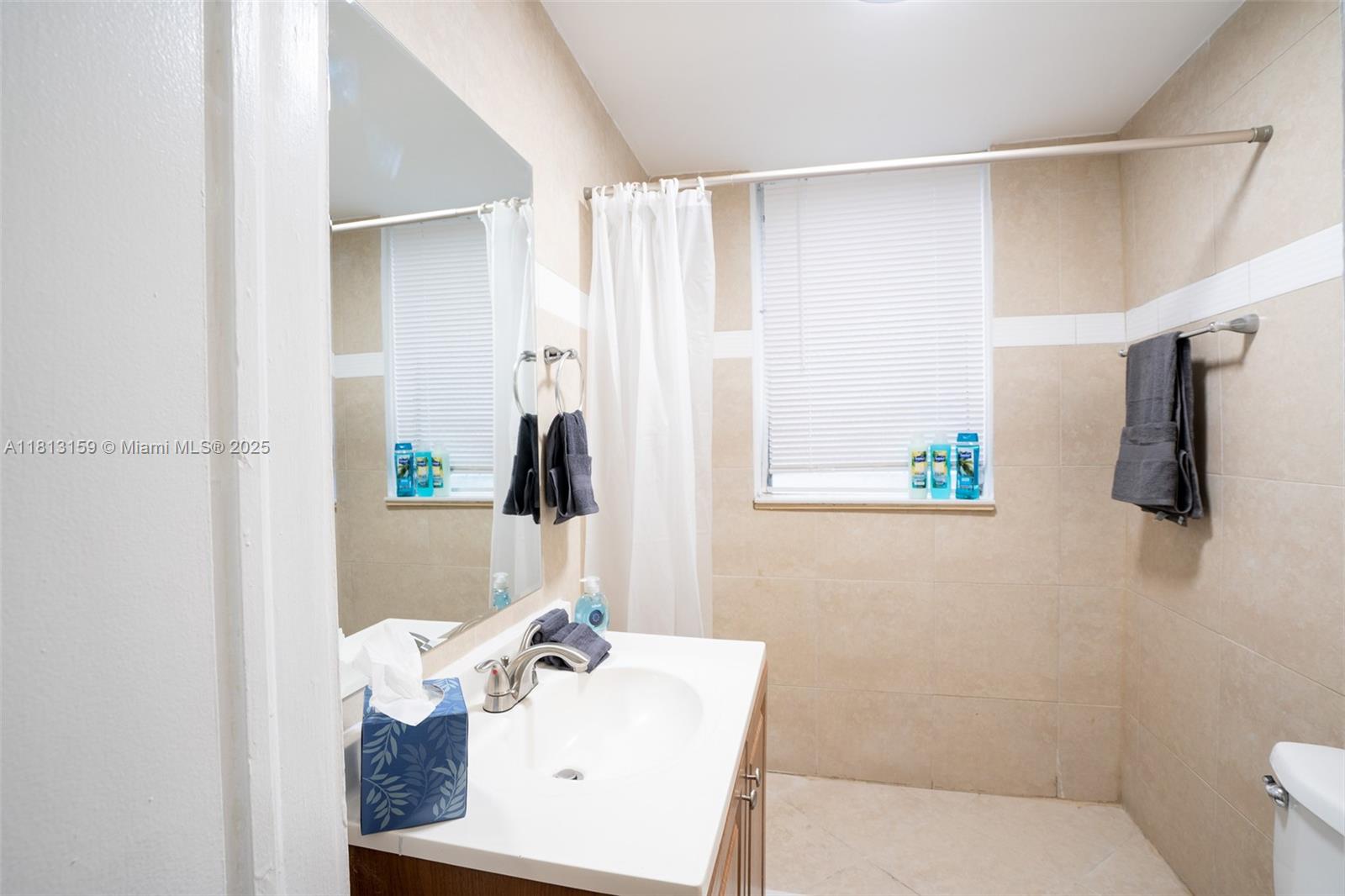 444 Ponce De Leon Boulevard, Unit 6 Coral Gables, FL 33134 - Photo 19 of 22 a bathroom with a sink and a mirror