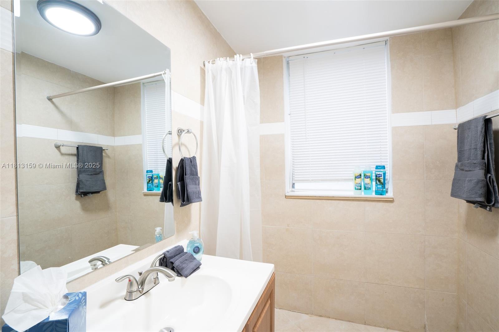 444 Ponce De Leon Boulevard, Unit 6 Coral Gables, FL 33134 - Photo 20 of 22 a bathroom with a sink and a mirror