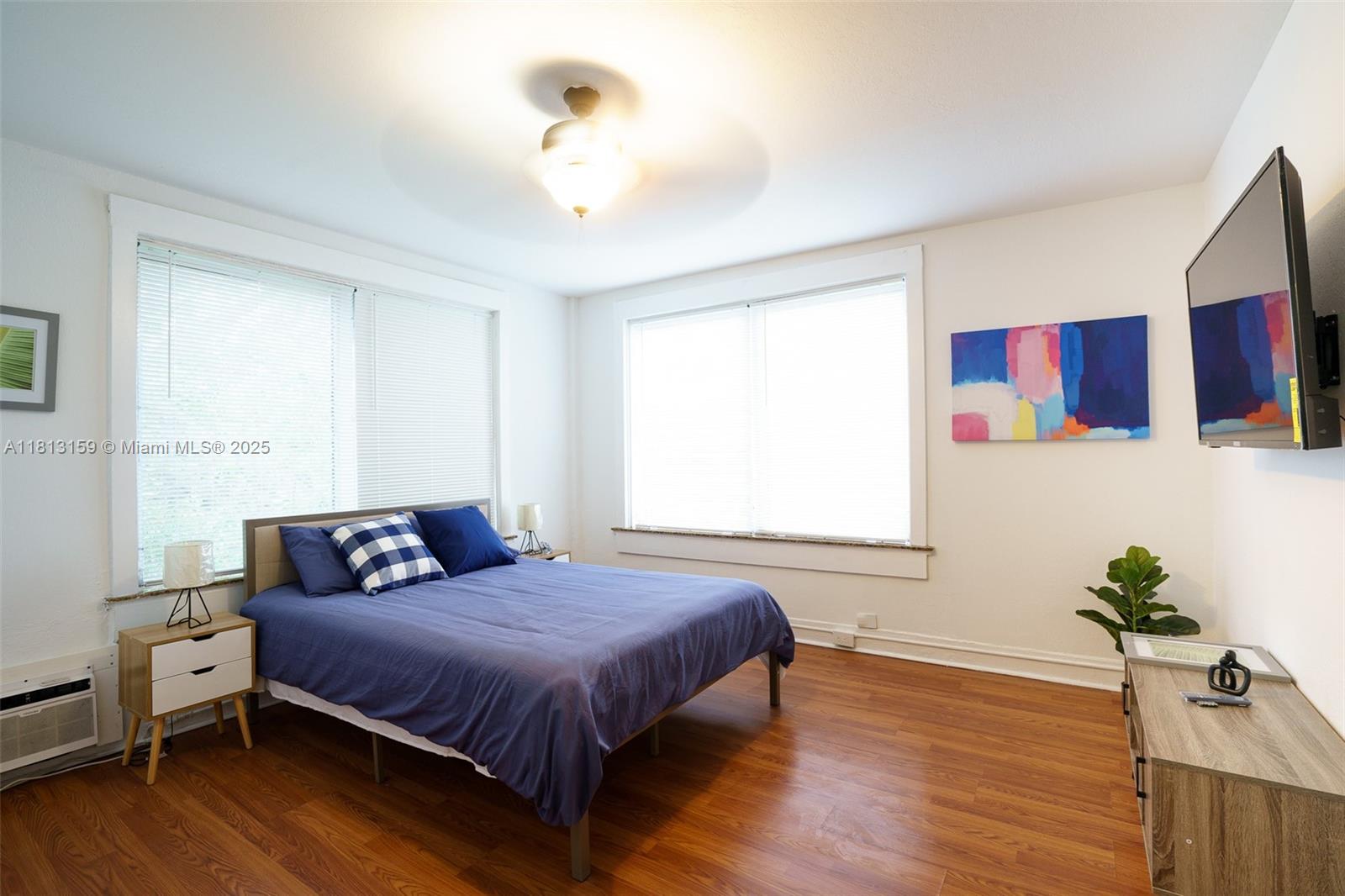 444 Ponce De Leon Boulevard, Unit 6 Coral Gables, FL 33134 - Photo 8 of 22 a bedroom with a bed and wooden floor