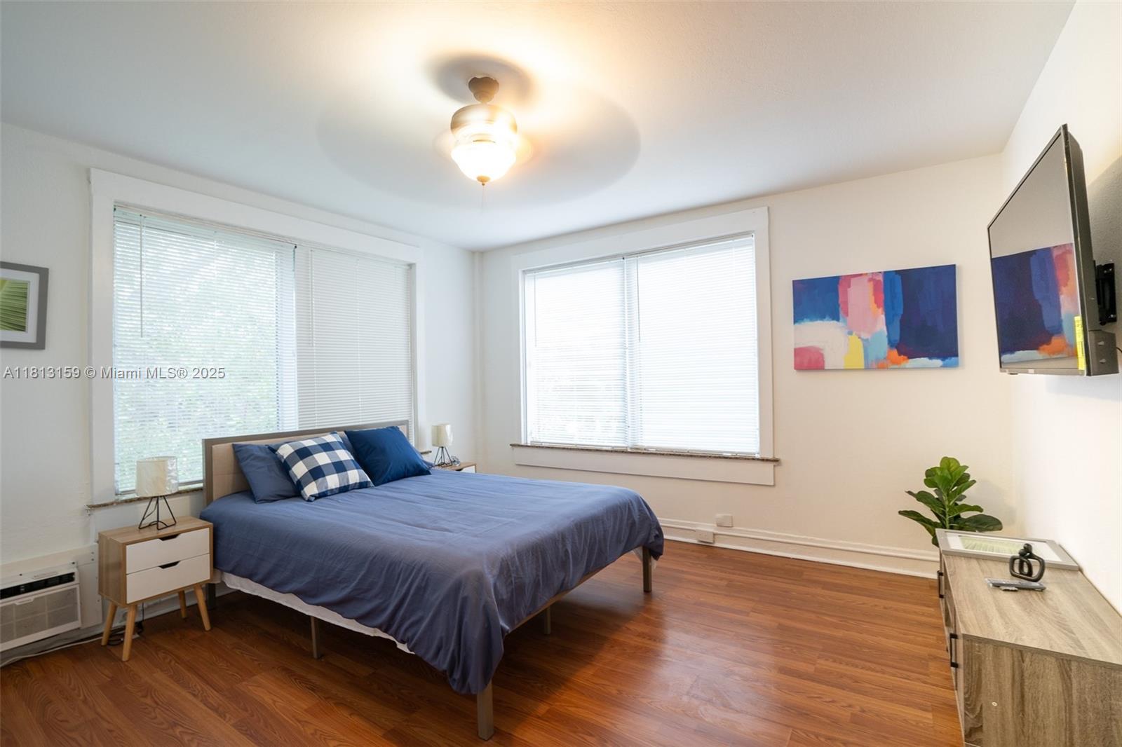 444 Ponce De Leon Boulevard, Unit 6 Coral Gables, FL 33134 - Photo 9 of 22 a bedroom with a large bed and a chandelier