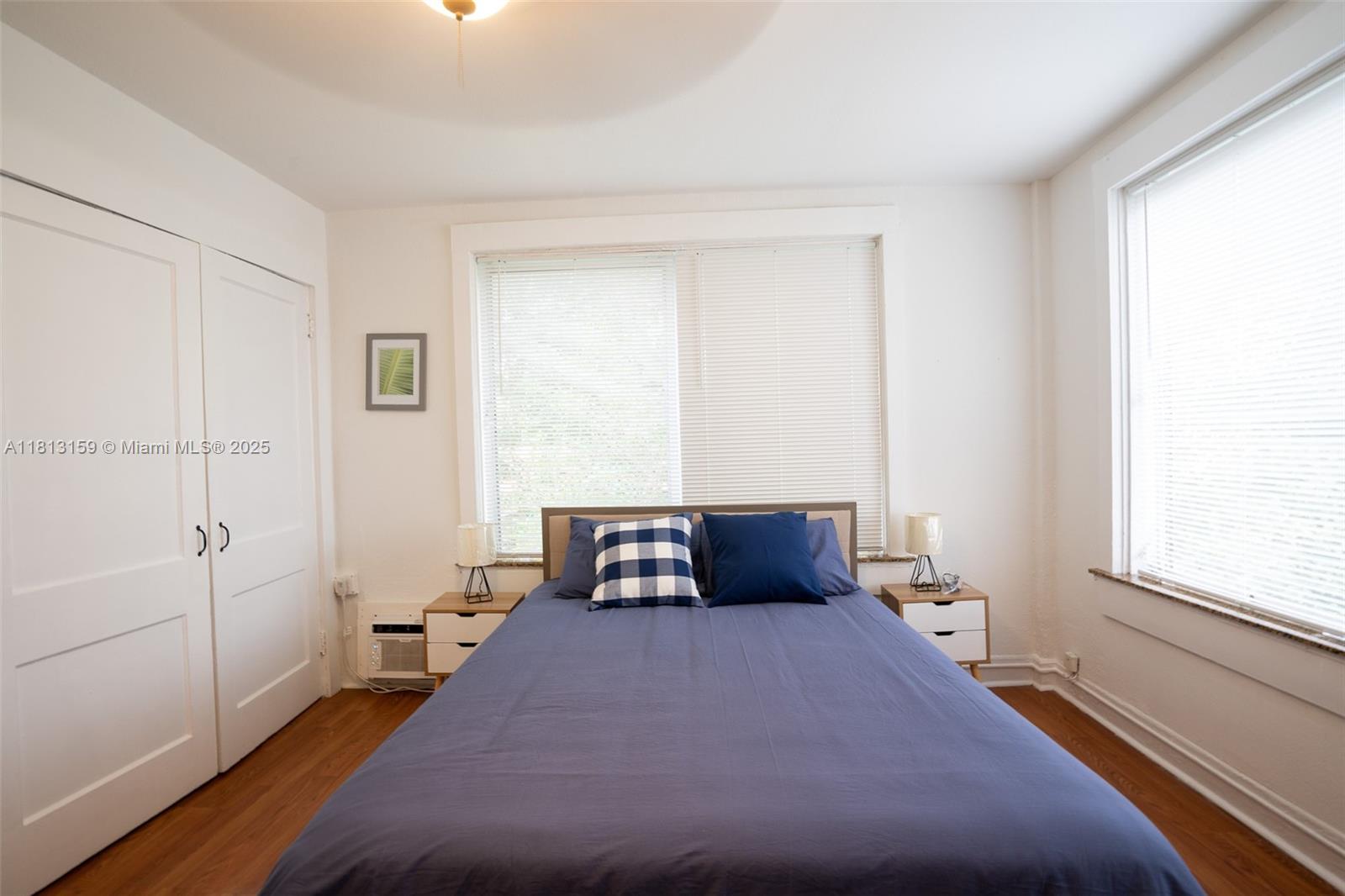 444 Ponce De Leon Boulevard, Unit 6 Coral Gables, FL 33134 - Photo 10 of 22 a bedroom with a bed and wooden floor