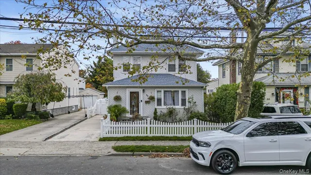 a front view of a house with a garden and plants