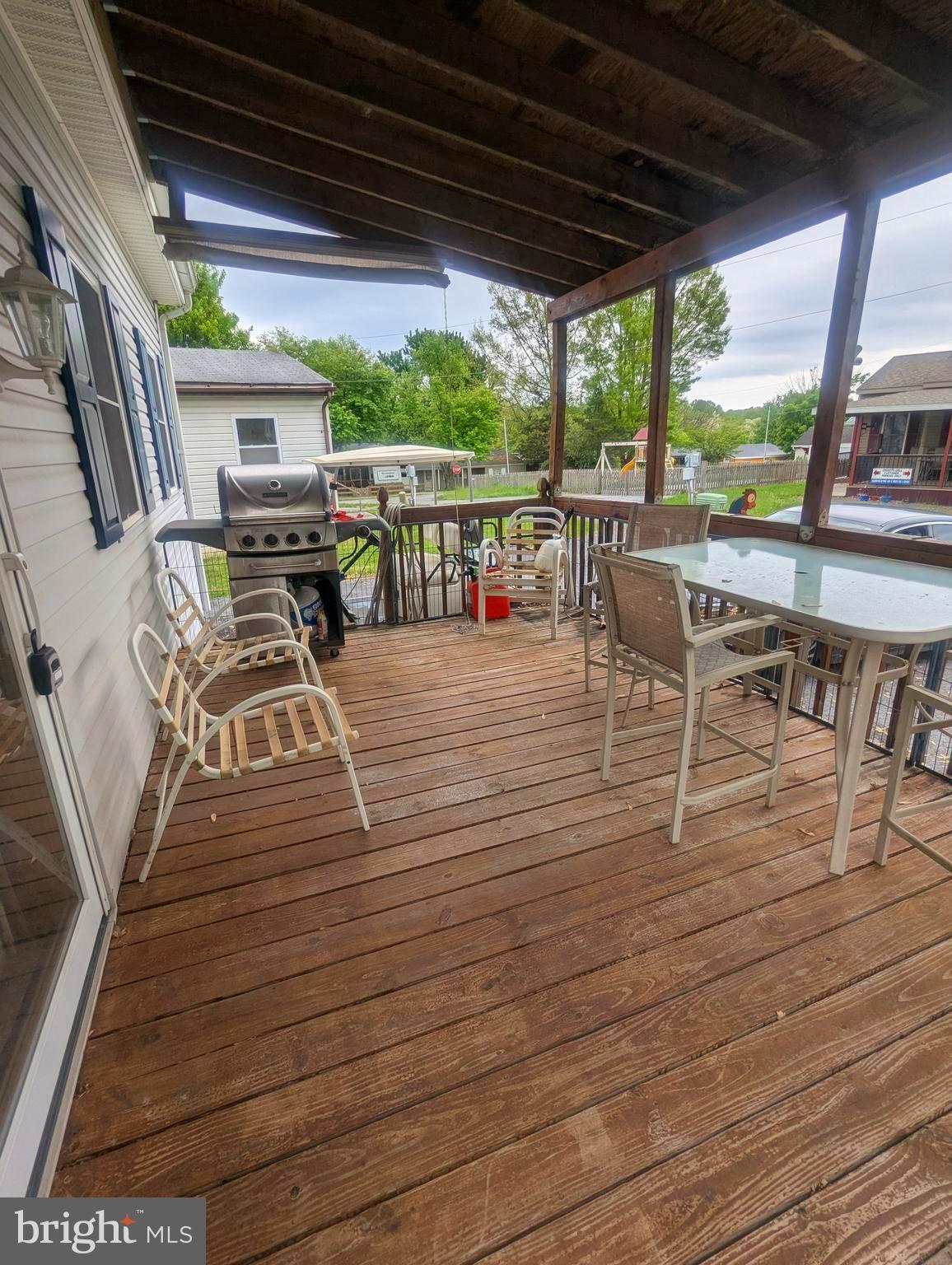 4 Hilo Road Falling Waters, WV 25419 - Photo 3 of 13 a view of a patio with table and chairs potted plants with wooden floor and fence