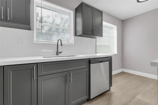 a kitchen with a sink cabinets and a window