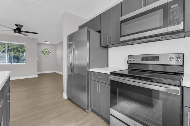 a kitchen with stainless steel appliances a stove and a refrigerator