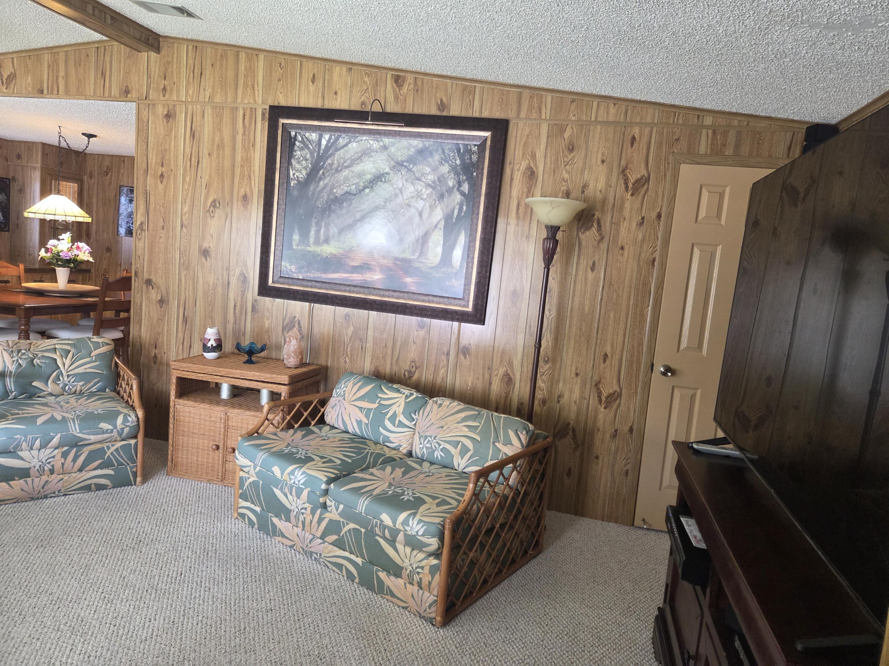 7375 Southeast Independence Avenue Hobe Sound, FL 33455 - Photo 17 of 25 a bedroom with a bed and a mirror