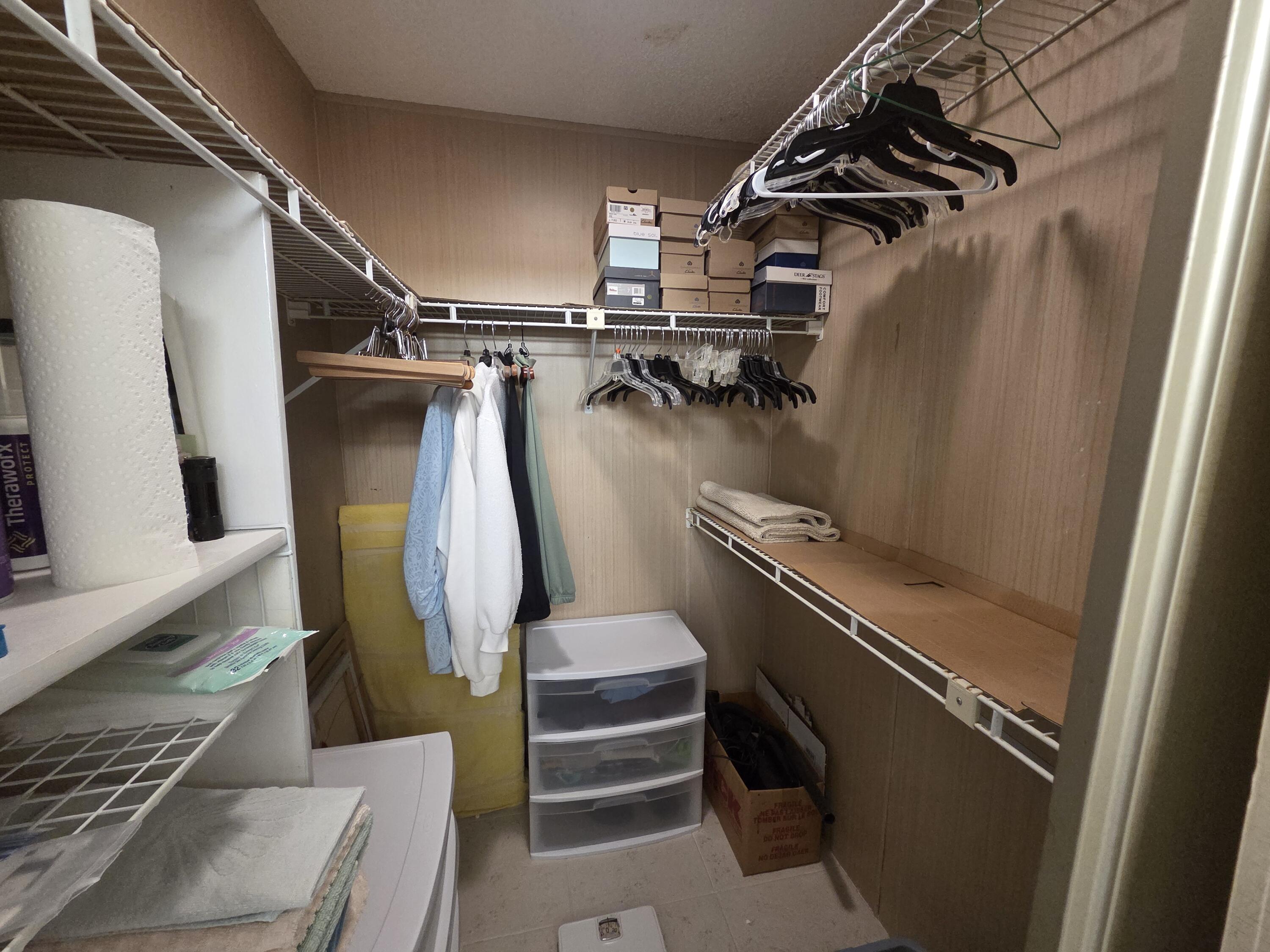 7375 Southeast Independence Avenue Hobe Sound, FL 33455 - Photo 23 of 25 a view of walk in closet with clothes and shoes