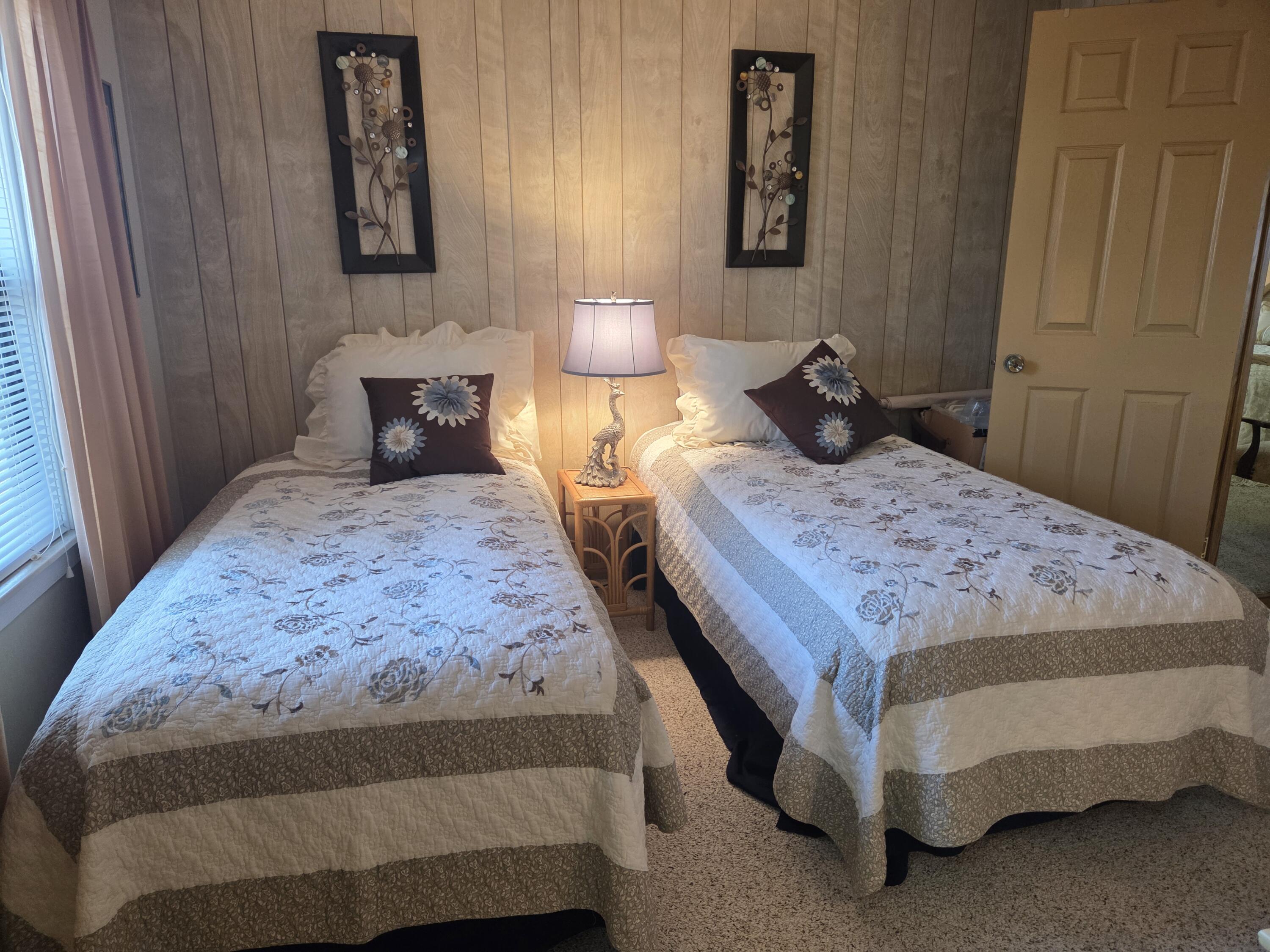 7375 Southeast Independence Avenue Hobe Sound, FL 33455 - Photo 24 of 25 a bedroom with a bed and lamp