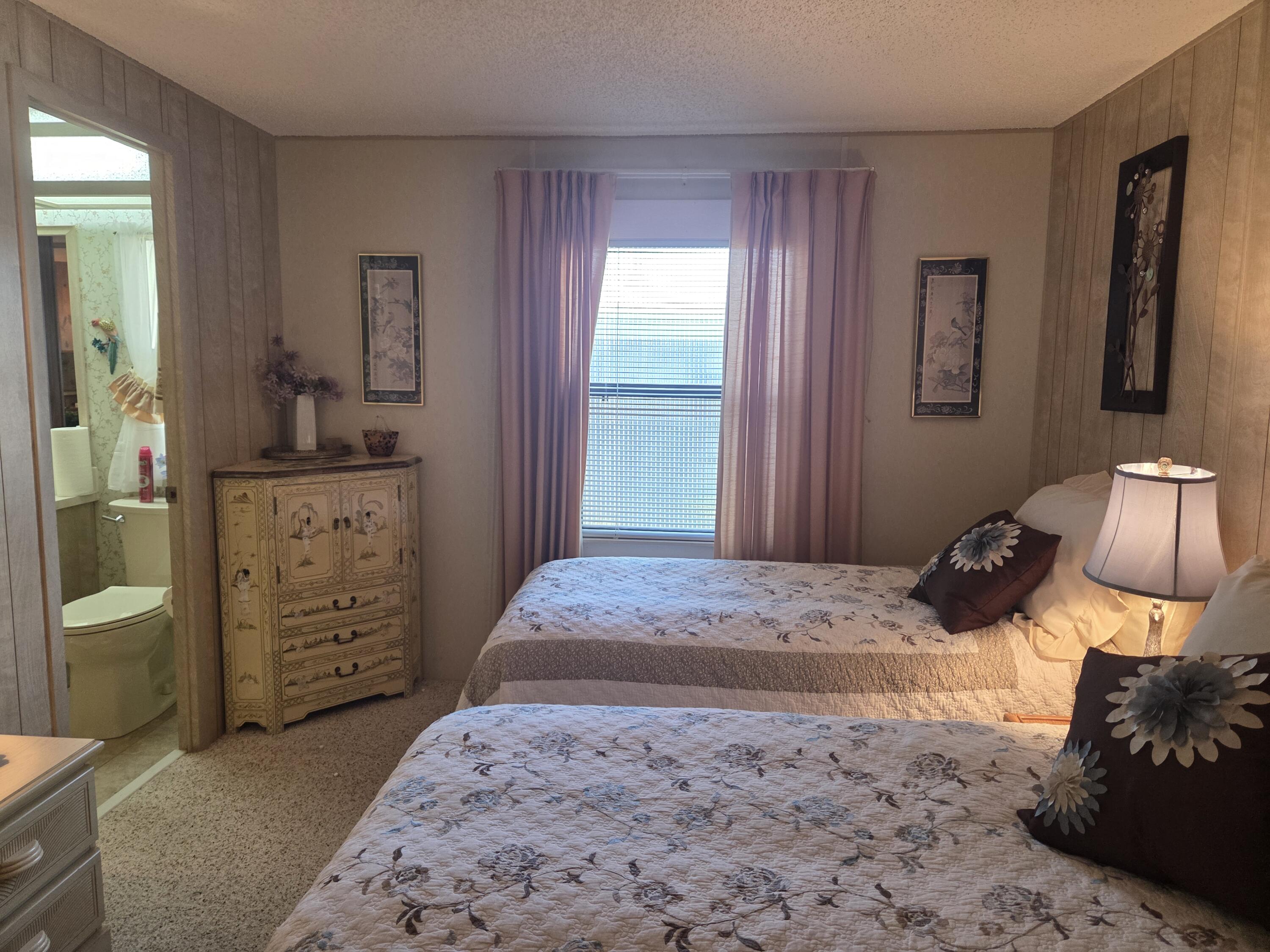 7375 Southeast Independence Avenue Hobe Sound, FL 33455 - Photo 25 of 25 a bedroom with a bed and a dresser in it