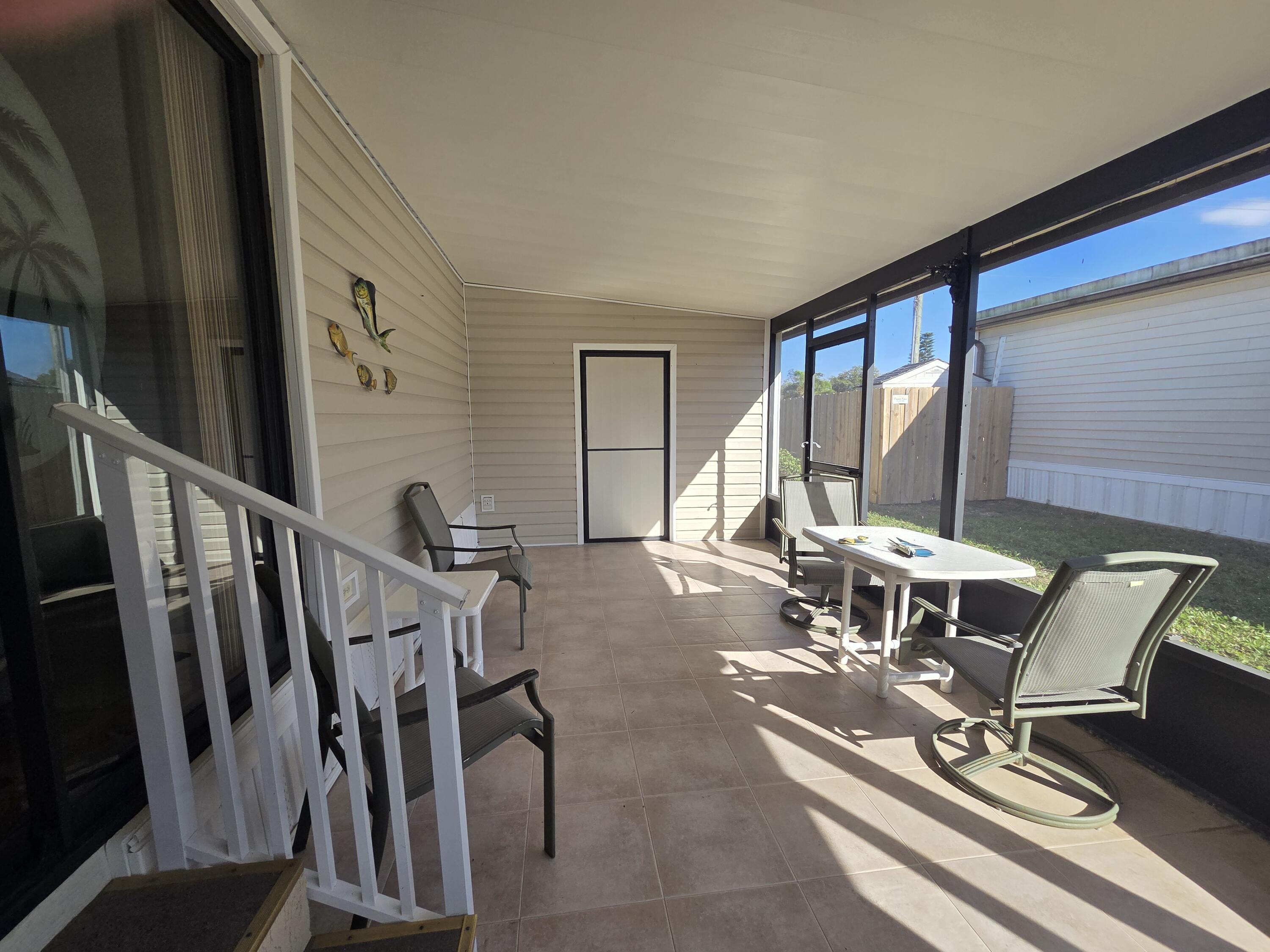 7375 Southeast Independence Avenue Hobe Sound, FL 33455 - Photo 5 of 25 a dining room with furniture and floor to ceiling window
