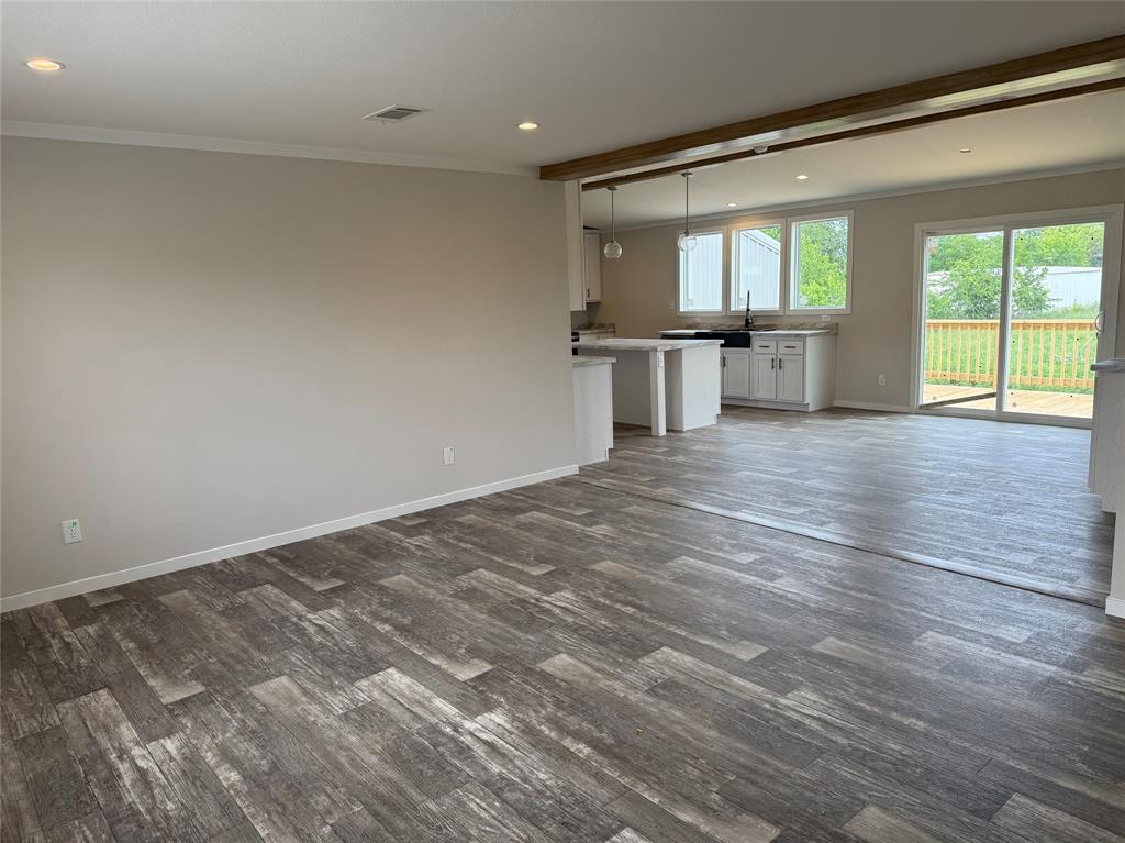 163 Red Fox Court Weatherford, TX 76088 - Photo 12 of 22 an empty room with wooden floor and windows