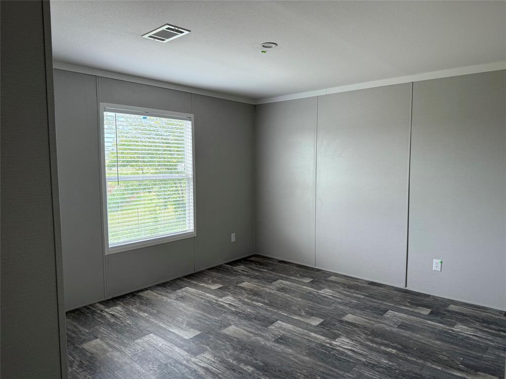 163 Red Fox Court Weatherford, TX 76088 - Photo 15 of 22 a view of an empty room with wooden floor and a window