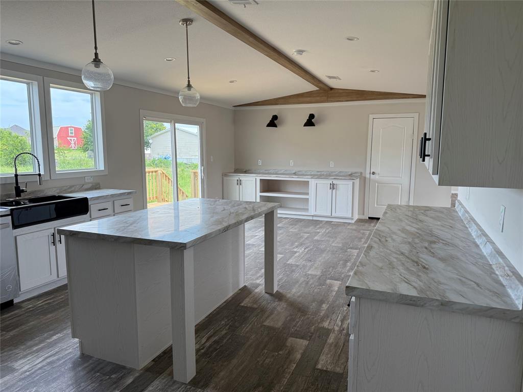 163 Red Fox Court Weatherford, TX 76088 - Photo 3 of 22 a kitchen with stainless steel appliances granite countertop a sink a stove and a wooden floors