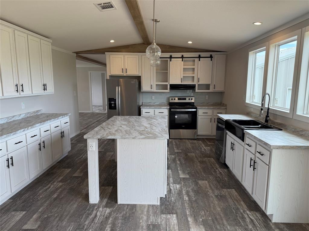163 Red Fox Court Weatherford, TX 76088 - Photo 5 of 22 a large kitchen with stainless steel appliances granite countertop a stove a sink dishwasher and a refrigerator