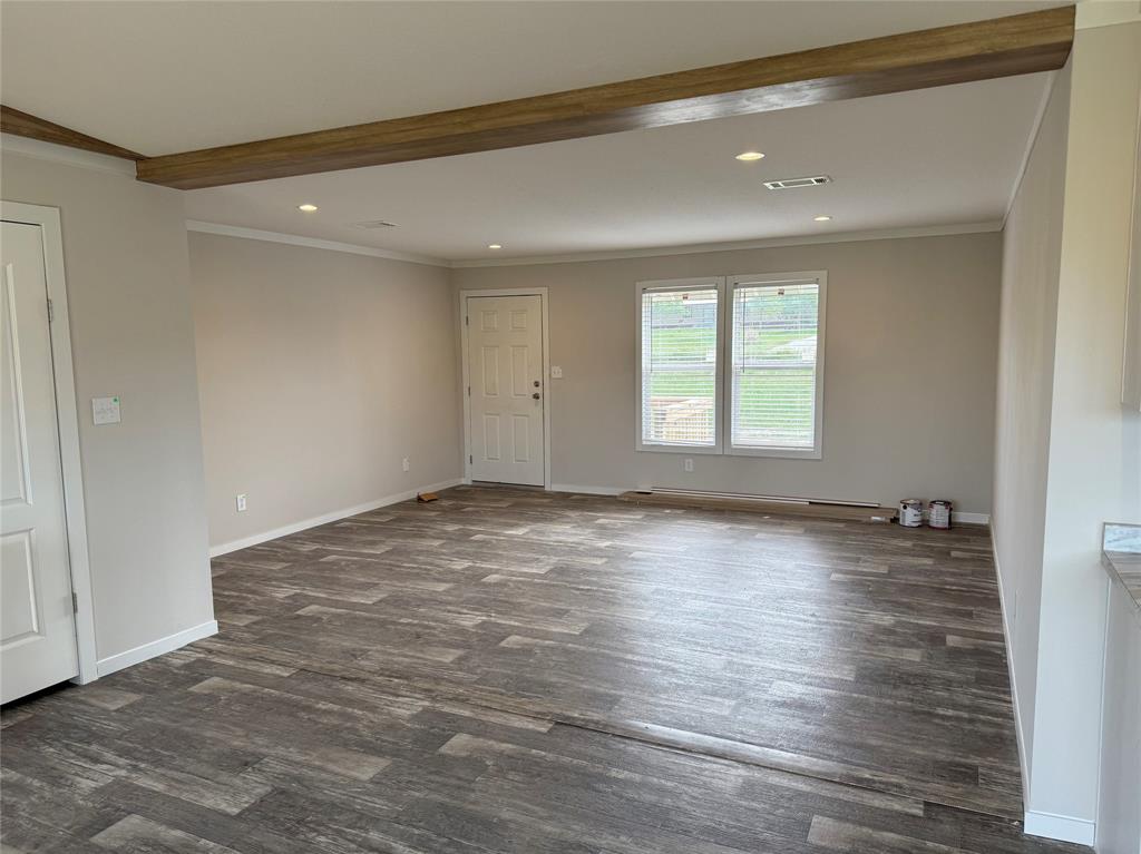 163 Red Fox Court Weatherford, TX 76088 - Photo 7 of 22 an empty room with wooden floor and windows