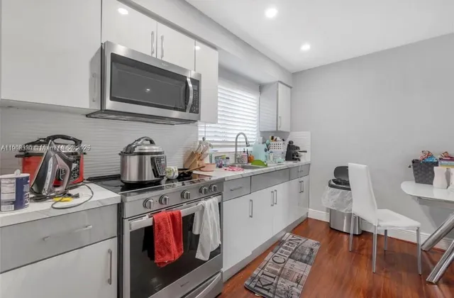 a kitchen with stainless steel appliances granite countertop a sink stove and microwave